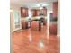 Spacious kitchen featuring wood floors, center island, granite countertops, and stainless steel appliances at 52 Olivia Ct, Palmetto, GA 30268
