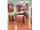 Updated kitchen with granite countertops, wood cabinets, center island, and stainless steel appliances at 52 Olivia Ct, Palmetto, GA 30268