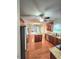 Open kitchen design featuring wood floors, a center island, stainless steel appliances, and views of the living area at 52 Olivia Ct, Palmetto, GA 30268