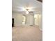 Large living area with cozy carpet, ceiling fan fixture, and open hallway layout at 52 Olivia Ct, Palmetto, GA 30268