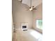 Spacious living room with high ceilings, a cozy fireplace, large window and carpet flooring at 52 Olivia Ct, Palmetto, GA 30268
