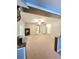 Large carpeted living room with adjacent doorways and display cabinets at 52 Olivia Ct, Palmetto, GA 30268