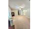 Open-concept living space with cozy carpet, built in cabinets, and lots of natural light at 52 Olivia Ct, Palmetto, GA 30268