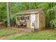 Charming backyard shed with decorative touches, a small porch, and a cozy bench at 52 Olivia Ct, Palmetto, GA 30268