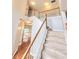 Elegant staircase with white railings and carpet treads leading to the upper level with view to window at 52 Olivia Ct, Palmetto, GA 30268