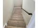Carpeted staircase with wooden handrail at 52 Olivia Ct, Palmetto, GA 30268
