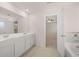 Double vanity bathroom with a large mirror and garden tub at 4084 Spencer Trl, Stonecrest, GA 30038