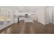 Open concept kitchen with white cabinets and access to backyard at 4084 Spencer Trl, Stonecrest, GA 30038