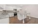 Modern kitchen with white cabinets, granite countertops and island at 4084 Spencer Trl, Stonecrest, GA 30038