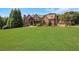 Spacious front yard of brick and stone home with luxurious curb appeal at 2145 Jones Phillips Rd, Dacula, GA 30019