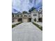 Street view of new construction townhomes each with driveway, one-car garage, and traditional architecture at 6202 Ripple Way # 88, South Fulton, GA 30349