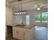 Kitchen island featuring granite counters, a sink, and a pendant light fixture, plus a view of the backyard at 6202 Ripple Way # 88, South Fulton, GA 30349