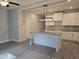 Open concept kitchen featuring granite counters, an island with a sink, and white cabinets at 6202 Ripple Way # 88, South Fulton, GA 30349