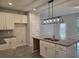 Kitchen with a granite island, stainless steel sink, stylish lighting, and a view to the outdoors at 6202 Ripple Way # 88, South Fulton, GA 30349