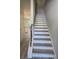 Bright staircase with wood-look treads leads to the upper level, adjacent to a neutral-toned kitchen space at 6202 Ripple Way # 88, South Fulton, GA 30349
