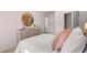 Bedroom featuring natural light, a decorative mirror, and a cozy bed with soft bedding and pillows at 126 Oakchase Park Ln, Hampton, GA 30228
