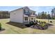 Two-story home featuring gray siding, a well-kept lawn, and landscaping at 126 Oakchase Park Ln, Hampton, GA 30228