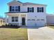 Charming two-story home boasts a two-car garage, welcoming porch, and classic black shutters at 126 Oakchase Park Ln, Hampton, GA 30228