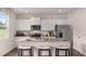 New kitchen features stainless appliances, granite countertops, gray cabinets and hardwood floors at 126 Oakchase Park Ln, Hampton, GA 30228