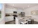 New kitchen features stainless appliances, granite countertops, gray cabinets and hardwood floors at 126 Oakchase Park Ln, Hampton, GA 30228