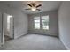 Spacious bedroom with neutral colors, a ceiling fan, carpet floors, and natural light from two windows at 6206 Ripple Way # 89, South Fulton, GA 30349
