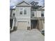 Charming two-story townhouse featuring a one-car garage and a welcoming entrance at 6206 Ripple Way # 89, South Fulton, GA 30349