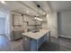 Well-lit kitchen boasts a large island, granite countertops, gray cabinets, and modern pendant lighting at 6206 Ripple Way # 89, South Fulton, GA 30349