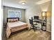 Bedroom with a plush bed, carpeted floor, desk, and natural light from a window at 6520 Roswell Rd # 59, Atlanta, GA 30328