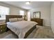 Serene bedroom with soft carpet, neutral walls, a large bed, and matching dresser at 6520 Roswell Rd # 59, Atlanta, GA 30328
