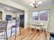 Cozy dining area with stylish furniture, modern lighting, wood flooring and a view of the kitchen at 6520 Roswell Rd # 59, Atlanta, GA 30328