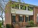 Charming brick townhouse featuring a private entry, well-maintained landscaping, and a welcoming facade at 6520 Roswell Rd # 59, Atlanta, GA 30328