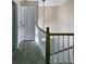 Bright hallway with modern lighting, neutral paint, carpet flooring, and a wooden railing at 6520 Roswell Rd # 59, Atlanta, GA 30328