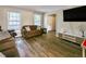 Cozy living room featuring hardwood floors, neutral walls, and comfortable seating arrangements at 6520 Roswell Rd # 59, Atlanta, GA 30328