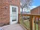 Balcony with wood railing, door to building, and neighborhood view at 6520 Roswell Rd # 59, Atlanta, GA 30328