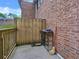 Private patio with wooden fence, brick wall, and room for seating or storage at 6520 Roswell Rd # 59, Atlanta, GA 30328