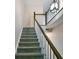 Carpeted staircase with white railing and wooden banister leading to the upper level of the home at 6520 Roswell Rd # 59, Atlanta, GA 30328