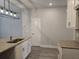 Modern kitchen with granite countertops, stainless steel sink, and stylish light fixture at 6214 Ripple Way # 91, South Fulton, GA 30349