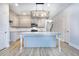 View of kitchen with gray cabinets, granite countertops, stainless steel appliances and a modern kitchen island at 6214 Ripple Way # 91, South Fulton, GA 30349