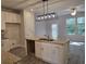Open kitchen featuring a granite island with double sinks and modern lighting at 6214 Ripple Way # 91, South Fulton, GA 30349