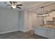 Spacious open floorplan showcases wood floors, a kitchen island, and stylish lighting at 6214 Ripple Way # 91, South Fulton, GA 30349