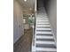 View of staircase and open floor plan with gray wood flooring and access to the kitchen at 6214 Ripple Way # 91, South Fulton, GA 30349