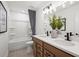 Bathroom with double vanity, bathtub, and gray tile floor at 6076 Marigold Way, Atlanta, GA 30349