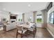 Bright dining area with wood table and chairs, adjacent to living room at 6076 Marigold Way, Atlanta, GA 30349