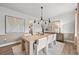 Elegant dining room with a long wooden table, modern art, and natural light at 6076 Marigold Way, Atlanta, GA 30349