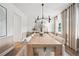 Open concept dining room with a rustic wooden table and neutral tones at 6076 Marigold Way, Atlanta, GA 30349