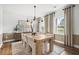 Bright dining room features a large wooden table, chandelier, and neutral colors at 6076 Marigold Way, Atlanta, GA 30349