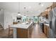 Open concept kitchen with island, stainless steel appliances, and light wood cabinets at 6076 Marigold Way, Atlanta, GA 30349