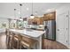 Modern kitchen with stainless steel appliances and an island with seating at 6076 Marigold Way, Atlanta, GA 30349