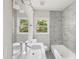 Bright bathroom with a double sink vanity, gray marble tile accent wall, tub, and a window with a green view at 1909 Meadow Ln, Decatur, GA 30032