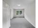 Bright bedroom with carpet flooring, white walls, and window at 1909 Meadow Ln, Decatur, GA 30032